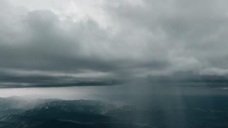 Aerial-of-storm-clouds-raining-down-on-mountain-range-1