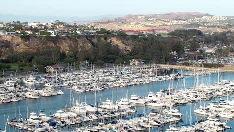 The-Marina-at-Dana-Point---ascending-aerial-view-of-the-harbor-and-surrounding-community-of-San-Clemente,-California