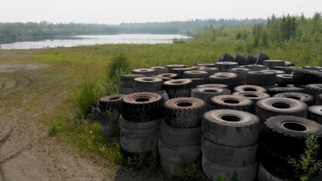 4K-Drone-Video-of-Discarded-Giant-Excavator-Tire-Pile-in-wilderness-near-Fairbanks,-AK-during-Summer-Day-2