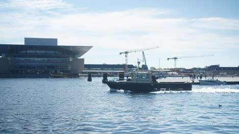 Boat-sailing-by-Copenhagen-Opera-House,-Denmark