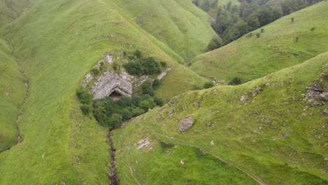 Prehistoric,-Arpea-Cave,-on-a-cold-misty-day-hidden-amongst-bright-green-hills