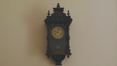 A-grandfather-clock-hanging-on-the-wall-reads-12:50-am