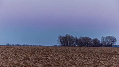 Timelapse-shot-of-colorful-sky-during-evening-time-over-agricultural-farmland
