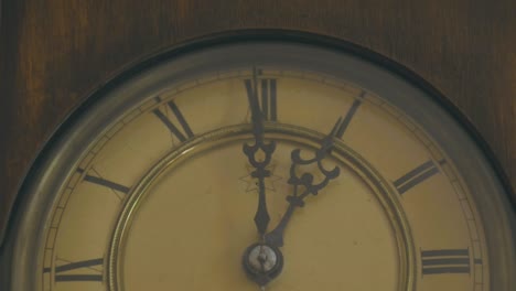 Detail-of-a-grandfather-clock-with-hands-and-Roman-numerals-to-mark-time,-it-is-1