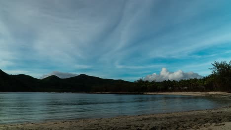 Water-rising-tide-on-tropical-island-beach-with-blue-sky-and-clouds,-timelapse