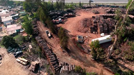 Aerial-View-Of-A-Sawmill-Facility-With-Stacked-Logs-Near-Curauma,-Chile