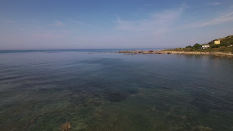 Shallow-water-of-sea-lagoon-near-rocky-coastline-of-Adriatic-sea-in-Durres,-Albania