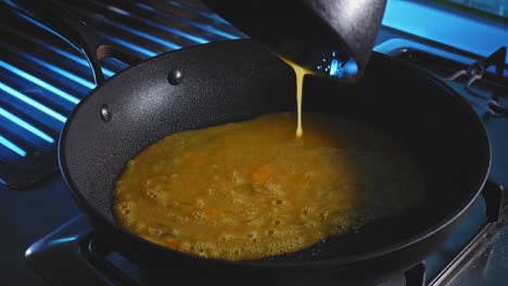 Pouring-Raw-Beaten-Eggs-Into-Hot-Skillet,-Then-Tortilla-Wrap-On-Top