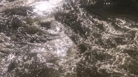 Close-up-view-of-powerful-water-flowing-in-a-natural-river,-long-video