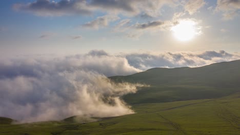Drone-Hyperlapse-Of-Clouds-Creeping-Over-Mountain-Valley-At-Sunset-In-Tkhilvana,-Georgia