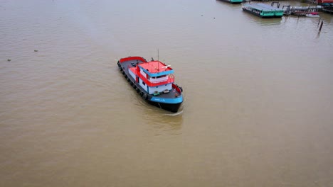 Aerial-Flying-Over-River-Tug-Boat-On-Chao-Phraya-In-Bangkok
