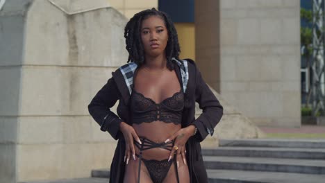 Young-African-girl-in-a-black-lingerie-outfit-walking-outdoors-in-the-city-of-Port-of-Spain,-Trinidad