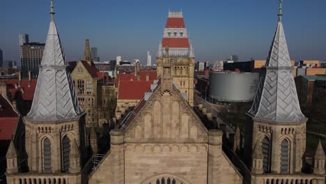 Aerial-drone-flight-over-the-rooftop-of-The-Universirty-of-Manchester-to-reveal-the-gothic-architecture-bleow