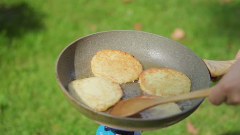 Potato-pancakes-baking-in-a-pan-with-oil-outside-during-the-summer-1