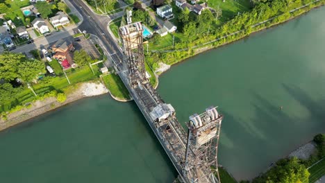 Aerial-Drone-Top-Notch-Above-Car-passing-through-Lift-Bridge-Crossing-Blue-River
