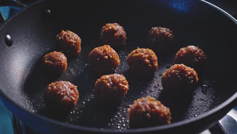 Placing-Raw-Meat-Balls-Into-Hot-Frypan-With-Coconut-Oil-For-Frying
