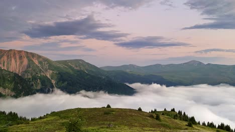 Time-Lapse-Of-Mountain-Skyline-With-Valley-Shrouded-By-Fluffy-Clouds-At-Sunset