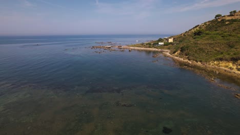 Rocky-coastline-of-Adriatic-sea-near-Durres-in-Albania,-pristine-beaches-with-pebbles-and-emerald-seawater
