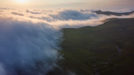 Cinematic-timelapse-of-fluffy-clouds-moving-softly-over-mountain-plateau-at-sunset