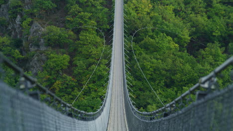Geierlay-suspension-bridge-wide-shot-in-morning-on-summer-day-tilt-up