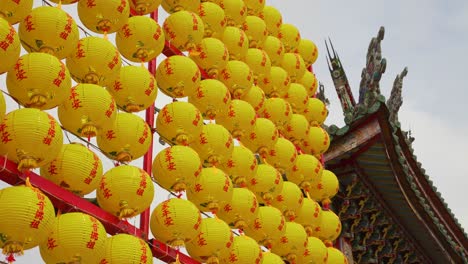 Yellow-lanterns-outside-Longshan-Temple-in-Taipei-City,-Taiwan