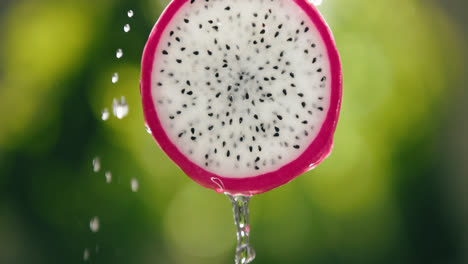 Water-Flowing-Down-Fresh-Dragon-Fruit-Slice-with-Liquid-Drip-in-Slow-Motion-Bright-Backlit-Background