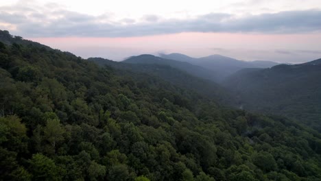Fast-aerial-push-over-treetops-at-sunrise-near-boone-and-blowing-rock-nc,-north-carolina