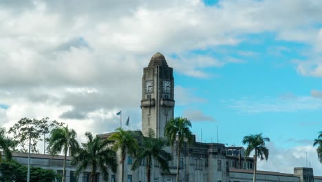 Government-Building-Suva-with-tall-tower-clock-and-clouds-moving-in-background,-timelapse