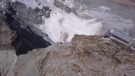 Aerial-view-from-drone-of-the-Refuge-Jean-Antoine-Carrel,-a-mountain-climbing-rest-stop-in-the-Alps-at-high-altitude-in-Aosta-Valley,-Italy-near-Matterhorn-peak