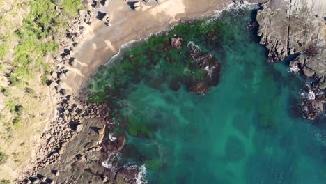 Drone-aerial-shot-of-crystal-clear-ocean-beach-Frazer-reef-rocky-headland-coastline-National-Park-Lake-Munmorah-Central-Coast-travel-tourism-NSW-Australia-4K