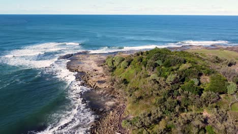 Drone-aerial-landscape-scenic-shot-of-bushland-nature-headland-coastline-rocky-reef-NSW-Yamba-Angourie-North-Coast-Tourism-travel-Pacific-Ocean-Australia-4K