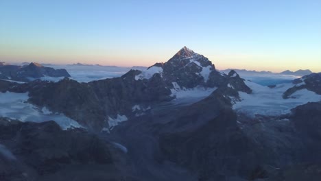 Beautiful-wide-aerial-sunrise-view-of-the-Matterhorn-peak-in-the-Alps-from-drone