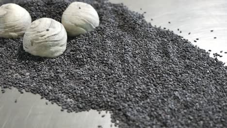 Gray-Chinese-Pastry-with-Black-Sesame-on-Table,-Close-Up