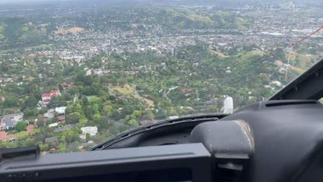 Helicopter-flying-over-mountain-neighborhood
