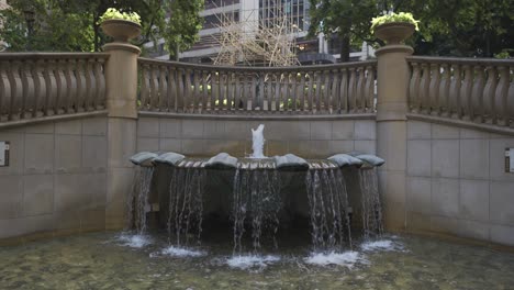 Slow-motion-shot-of-a-fountain-in-a-city-during-the-day