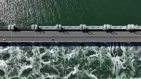Aerial-top-down-shot-of-car-driving-on-Zeeland-Bridge-at-Delta-Works-Construction-Projects-in-netherlands-during-sunny-day---Storm-surge-barrier-against-flood