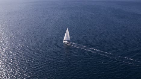 Sailing-boat-cruising-in-blue-water-of-Adriatic-Sea,-aerial