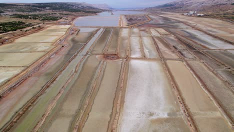 Salt-production-field-with-shallow-sea-water-pools,-evaporation-process