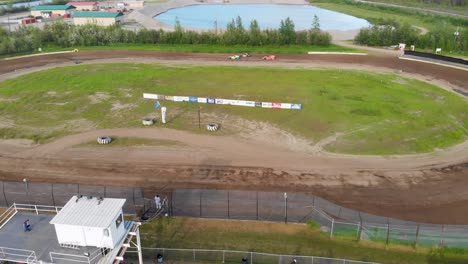 4K-Drone-Video-of-Stock-Car-Racing-at-Mitchell-Raceway-in-Fairbanks,-AK-during-Sunny-Summer-Evening
