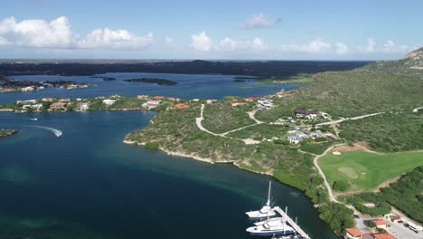 Aerial-view-of-island-with-boats-and-mountains-golf-court-ocean-view-sail-boats-marina-1