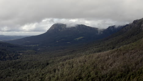 Aerial:-Drone-flying-towards-Mount-Roland-on-a-cloudy-day-in-Tasmania,-Australia