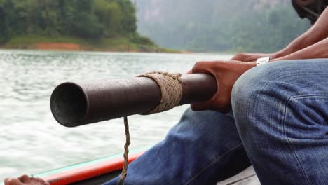 A-man-is-driving-a-longtail-boat-in-the-area-of-Khao-Sok-National-Park-in-south-Thailand