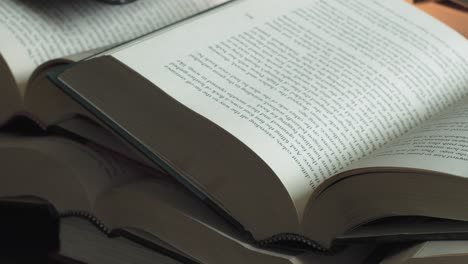 Pile-of-open-books-Slider-Shot-Left-to-Right-Close-Up