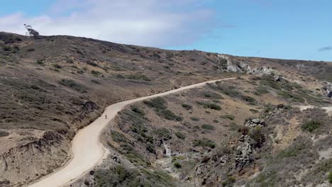 Solo-Bicyclist-riding-dirt-road-on-Catalina-Island-Backcountry-California