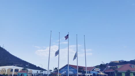 Flag-of-St-Thomas-Virgin-Island-and-USA-waving-on-poll-on-Port-of-St-Thomas-Virgin-island-|-St-Thomas-Flag-waving-on-half-mast-to-honoring-victims-of-tragedy-video-background-in-4K