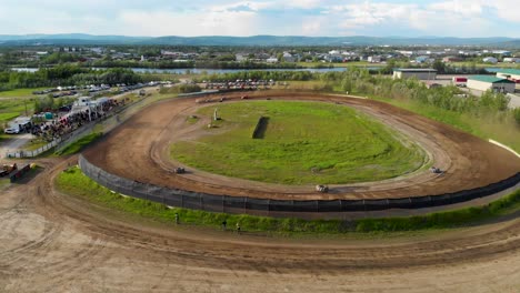 4K-Drone-Video-of-Modified-Stock-Car-Racing-at-Mitchell-Raceway-in-Fairbanks,-AK-during-Sunny-Summer-Evening-1