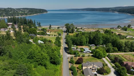 Aerial-shot-flying-down-Freeland's-main-street-towards-Holmes-Harbor-on-Whidbey-Island