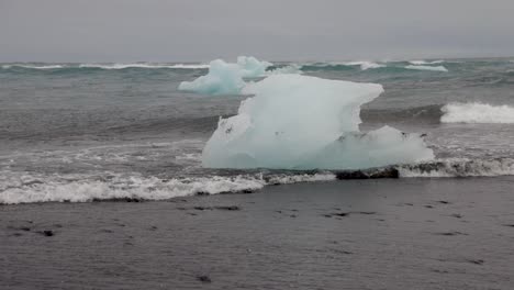 Gletscherlagune-In-Island-Mit-Kleinen-Wellen,-Die-Auf-Eisbrocken-Treffen