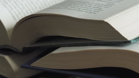 Pile-of-open-books-Slider-Shot-Macro-Close-Up-Left-to-Right-Slide