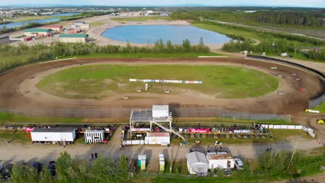 4K-Drone-Video-of-Stock-Car-Racing-at-Mitchell-Raceway-in-Fairbanks,-AK-during-Sunny-Summer-Evening-4